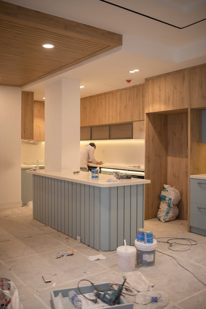 gallery-05 Contemporary kitchen undergoing renovation with wooden cabinets and clean design.